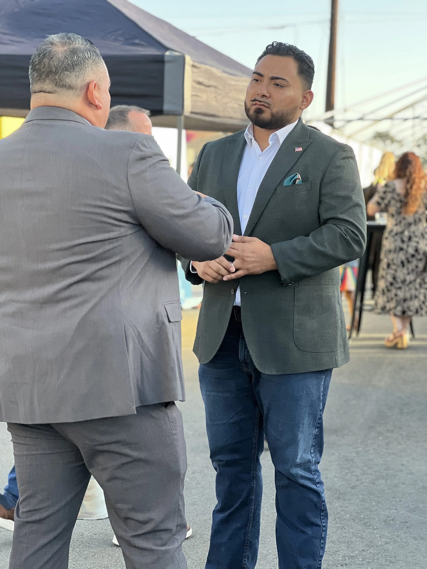Guillermo greeting a supporter at an event.