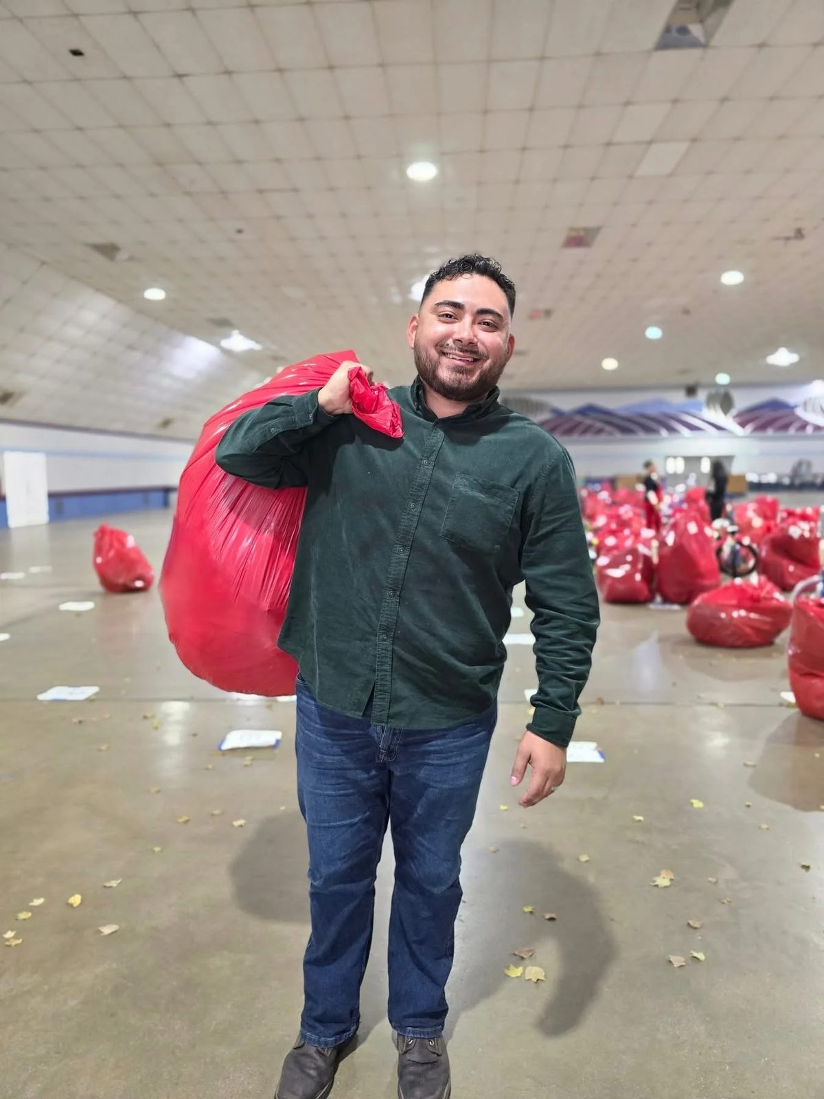 Guillermo carrying supplies at a community event.